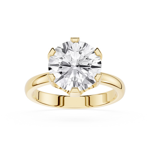 Gold ring with a large diamond on a white background