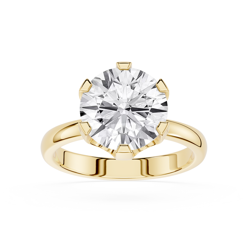 Gold ring with a large diamond on a white background