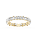 A yellow gold eternity ring featuring a continuous row of baguette-cut clear diamonds on the top and smaller round diamonds on the sides, set against a plain white background.