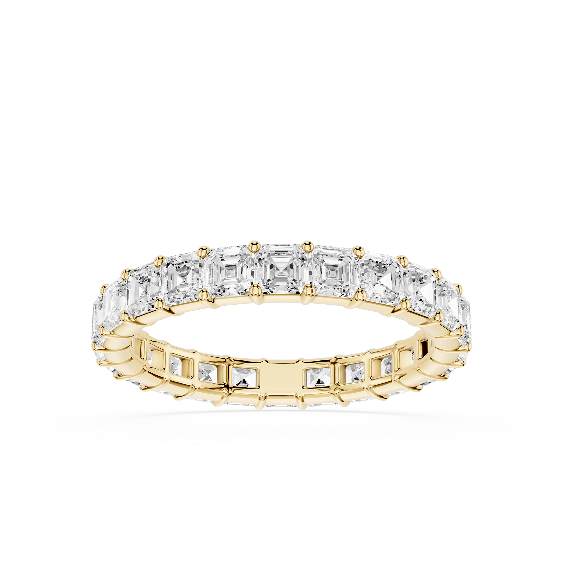 A yellow gold eternity ring featuring a continuous row of baguette-cut clear diamonds on the top and smaller round diamonds on the sides, set against a plain white background.
