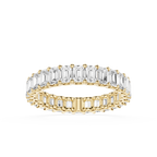 A yellow gold eternity ring featuring a double row of baguette-cut clear gemstones, shown on a clean white background.