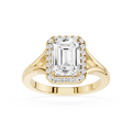 Gold ring with emerald-cut diamond and smaller diamonds on a white background