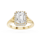 Gold ring with emerald-cut diamond and smaller diamonds on a white background