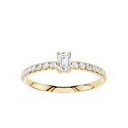 Gold ring with emerald-cut diamond and smaller diamonds on a white background