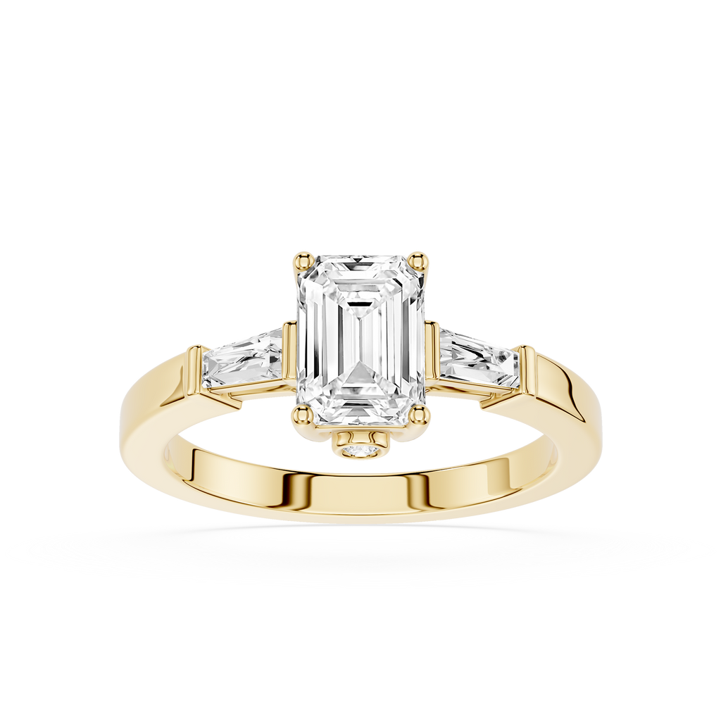Gold ring with emerald-cut diamond and baguette side stones on a white background