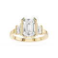 Gold ring with emerald-cut diamond on a white background