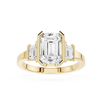 Gold ring with emerald-cut diamond on a white background