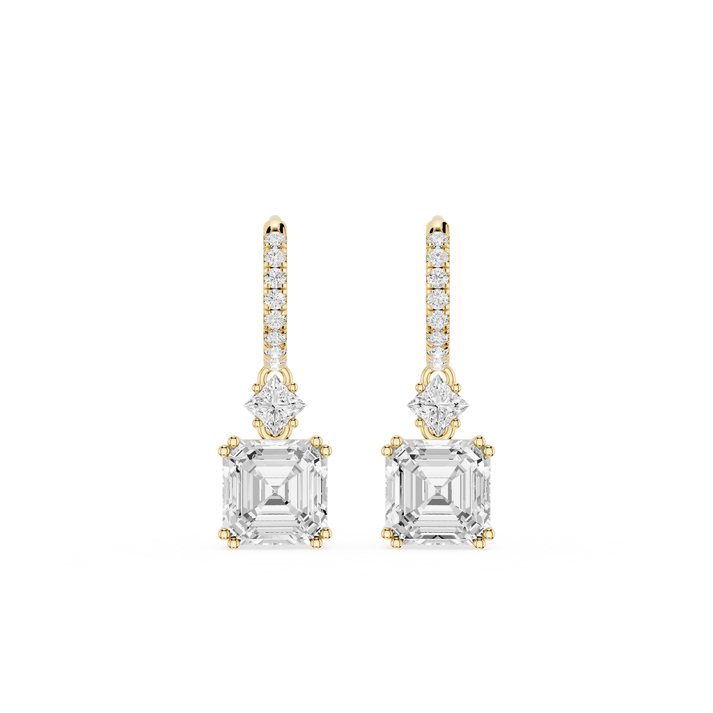 Gold and diamond earrings on a white background