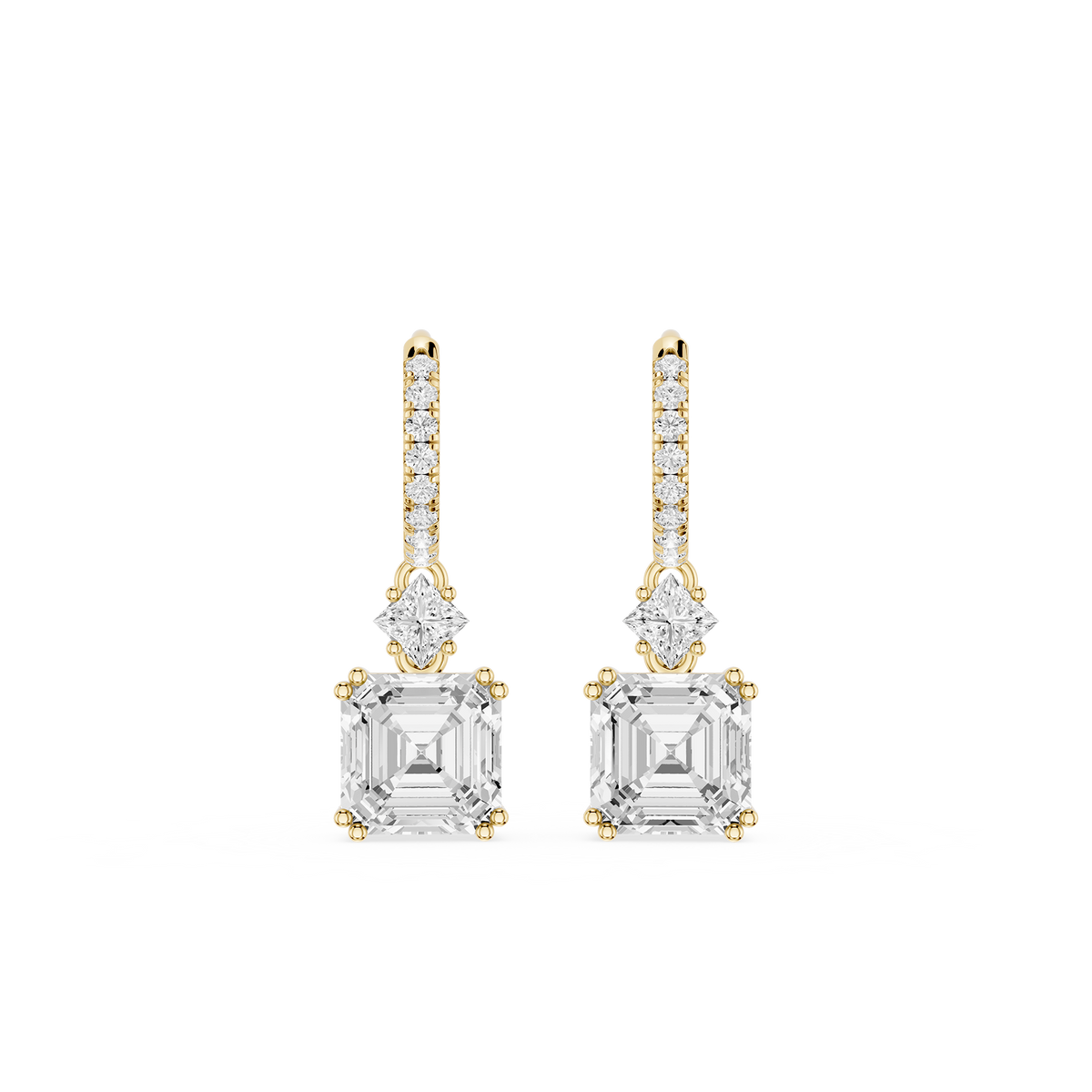 Gold and diamond earrings on a white background