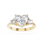 Gold ring with a heart-shaped diamond and smaller diamonds on a white background