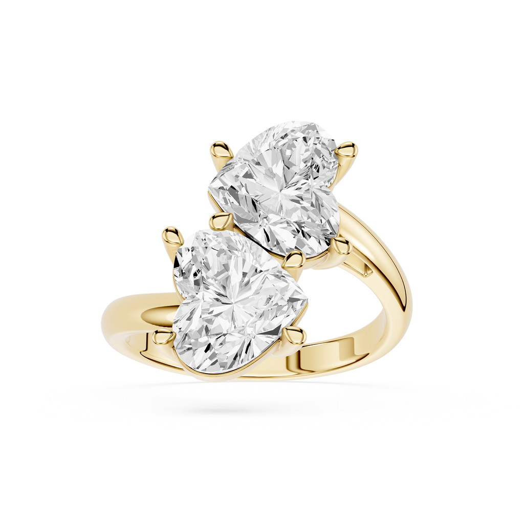 A yellow gold ring featuring two large pear-cut clear gemstones in a split-prong setting, shown on a clean white background.