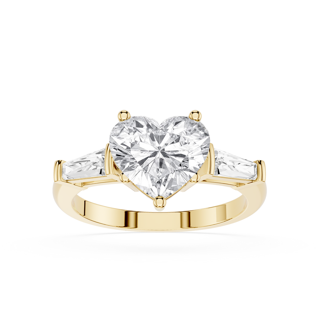 Gold ring with a heart-shaped diamond and two smaller diamonds on a white background