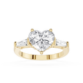 Gold ring with a heart-shaped diamond and two smaller diamonds on a white background