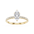 Gold ring with a pear-shaped diamond and smaller diamonds on a white background
