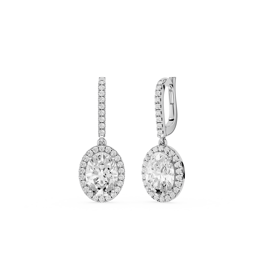 Pair of silver earrings with clear gemstones on a white background