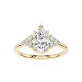 Gold ring with a pear-shaped diamond and smaller diamonds on a white background