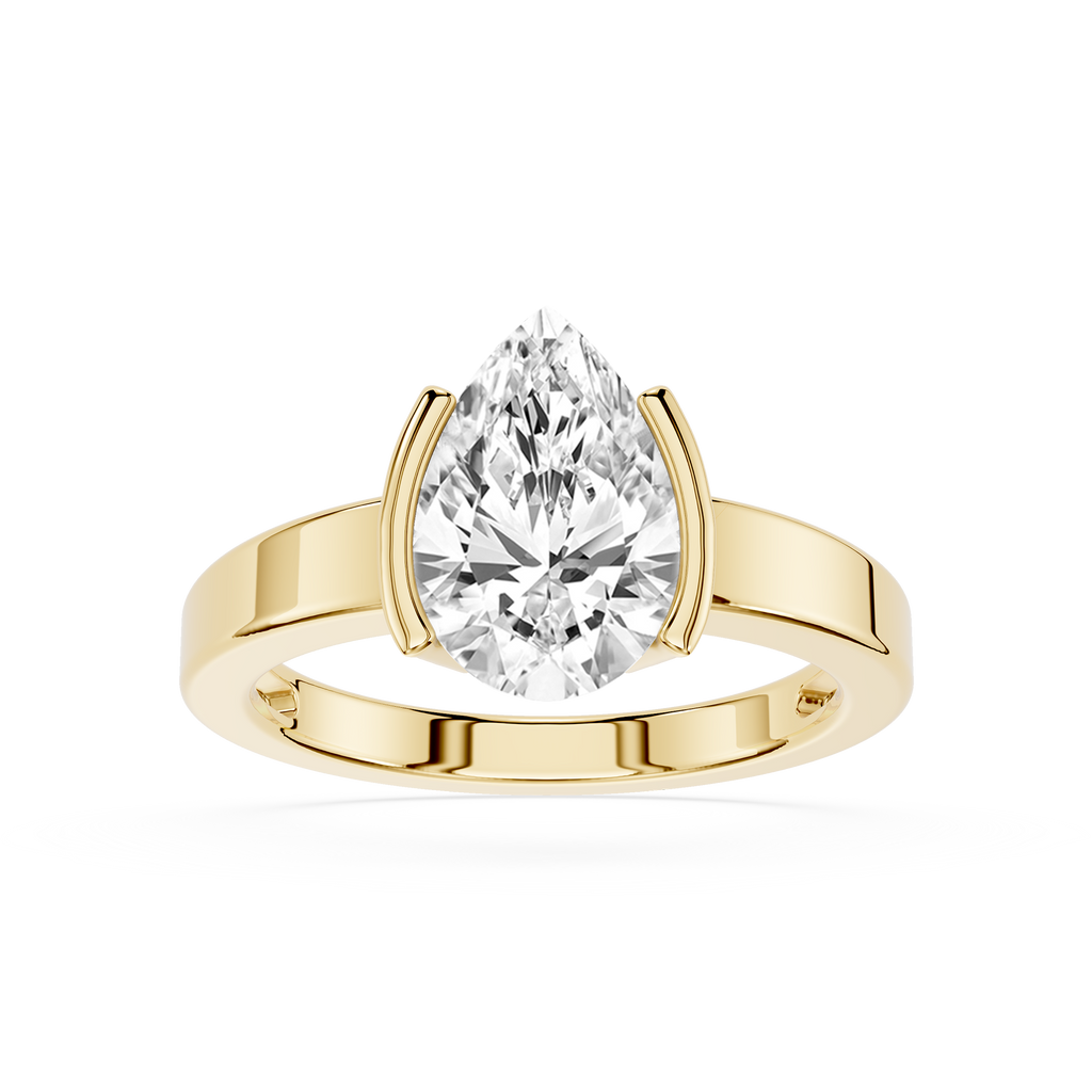 Gold ring with a pear-shaped diamond on a white background
