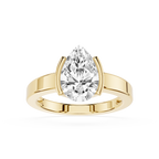 Gold ring with a pear-shaped diamond on a white background