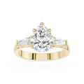 Gold ring with a large pear-shaped diamond on a white background