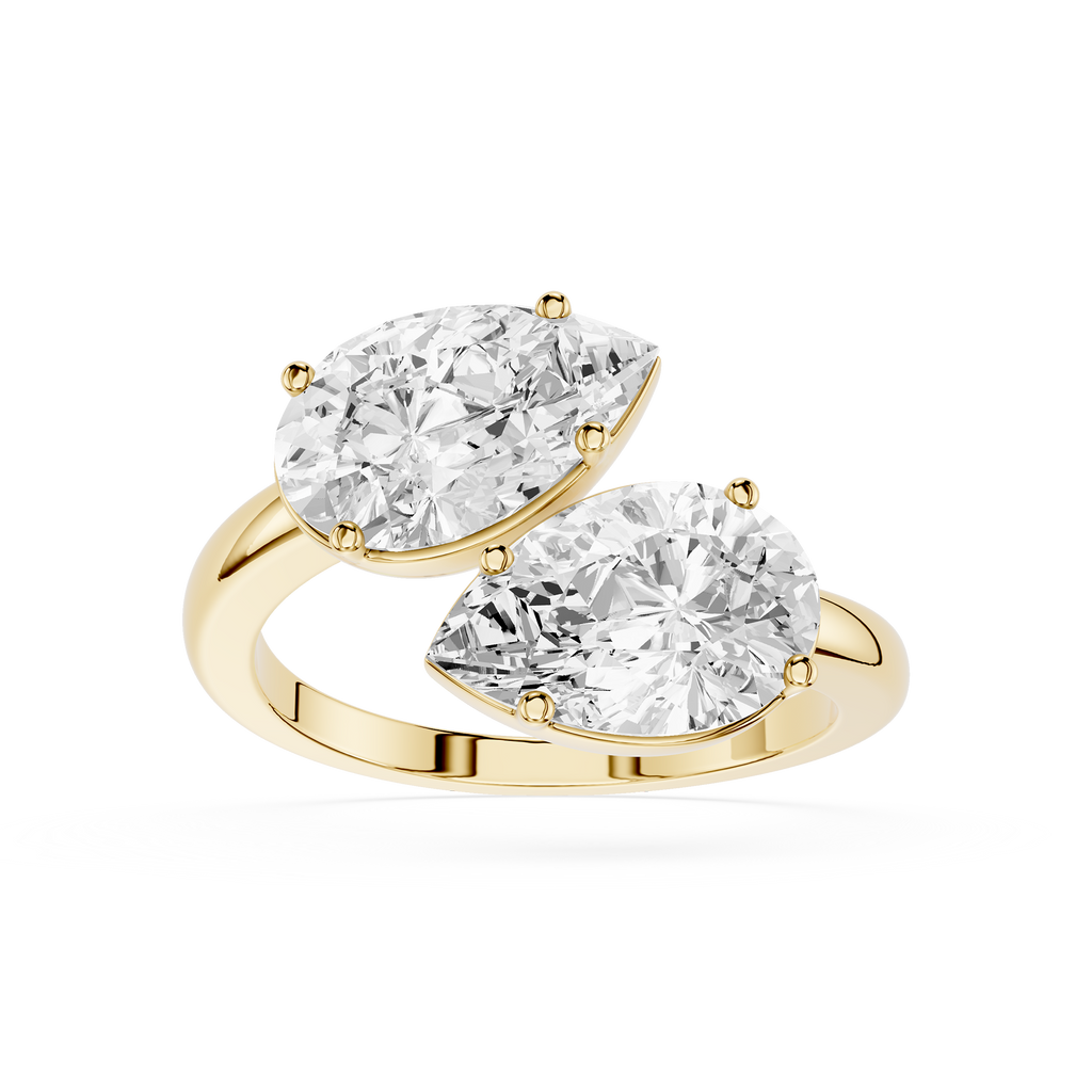 Gold ring with two pear-shaped diamonds on a white background