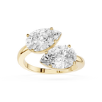 Gold ring with two pear-shaped diamonds on a white background