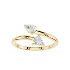 A yellow gold ring featuring two triangular-cut clear gemstones in a split-band design, set against a plain white background.