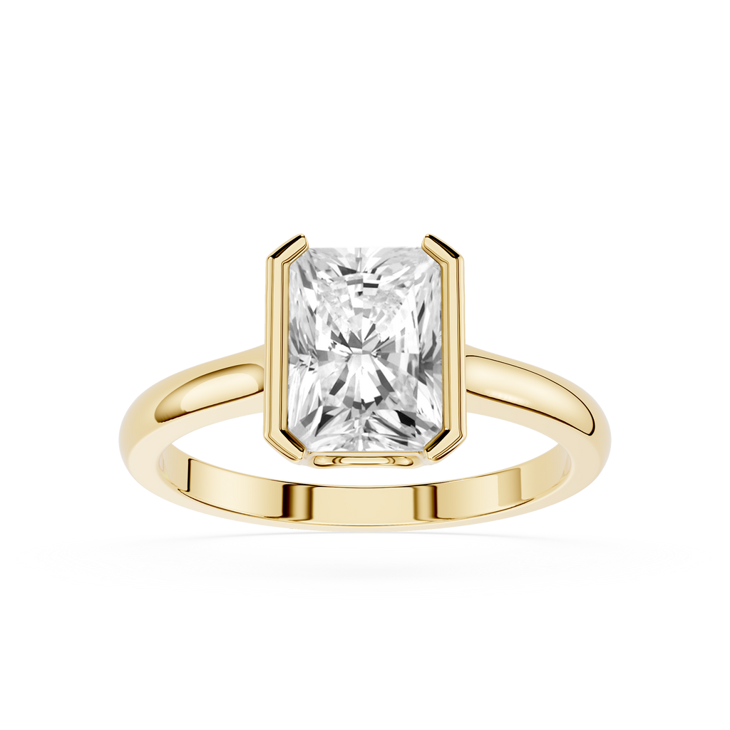Gold ring with a large rectangular diamond on a white background