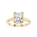 Gold ring with a large rectangular diamond on a white background