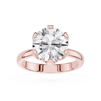 Rose gold ring with a large diamond on a white background