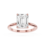 Rose gold ring with a large emerald-cut diamond on a white background