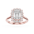 Rose gold halo ring featuring an emerald-cut center diamond surrounded by a double halo of smaller round and baguette-cut diamonds, set on a polished rose gold band against a white background.