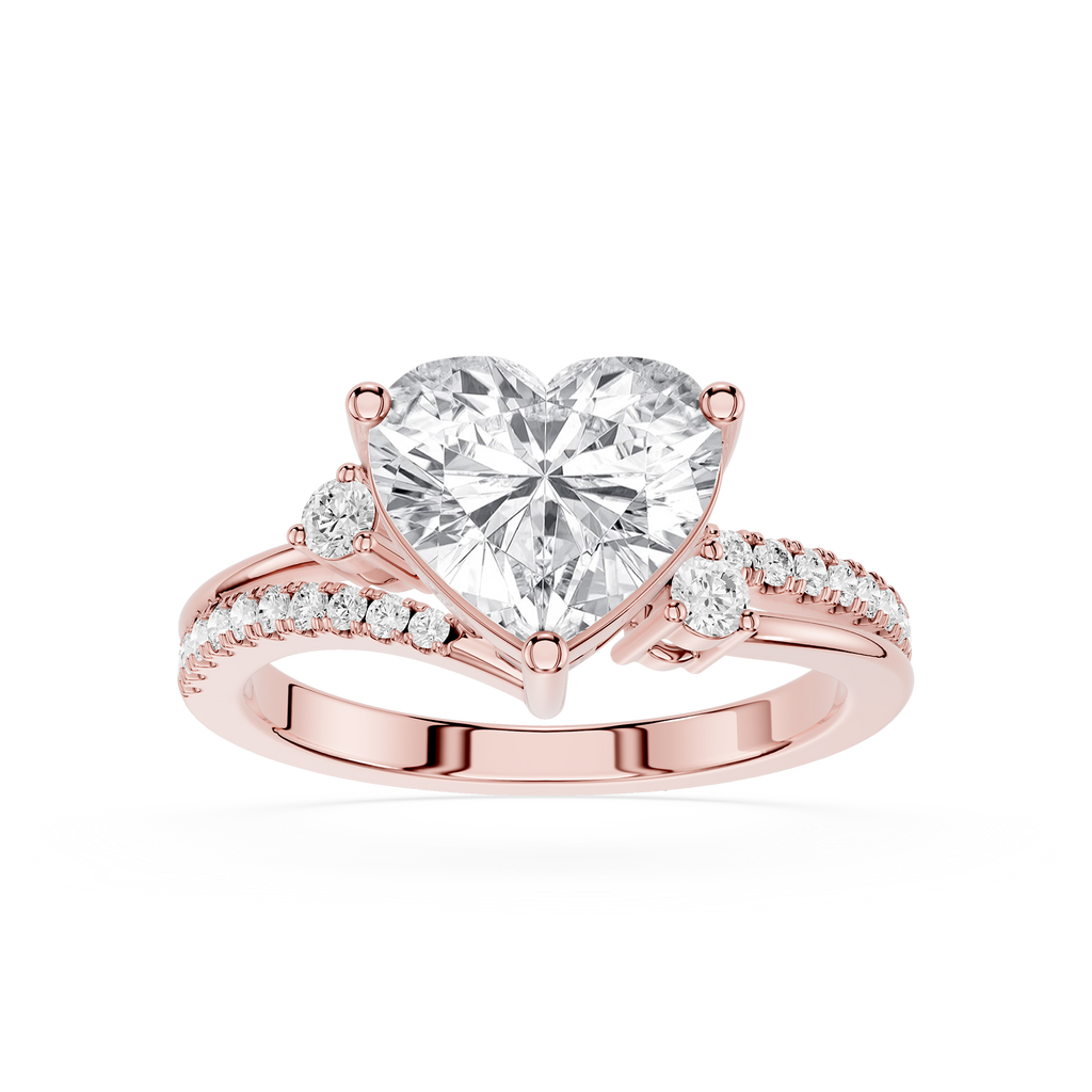 A rose gold engagement ring featuring a large heart-shaped clear gemstone in a prong setting, with a split band adorned with small pavé diamonds on a clean white background.