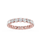 A rose gold eternity ring featuring a continuous row of round-cut clear gemstones in a prong setting, shown against a solid white background.