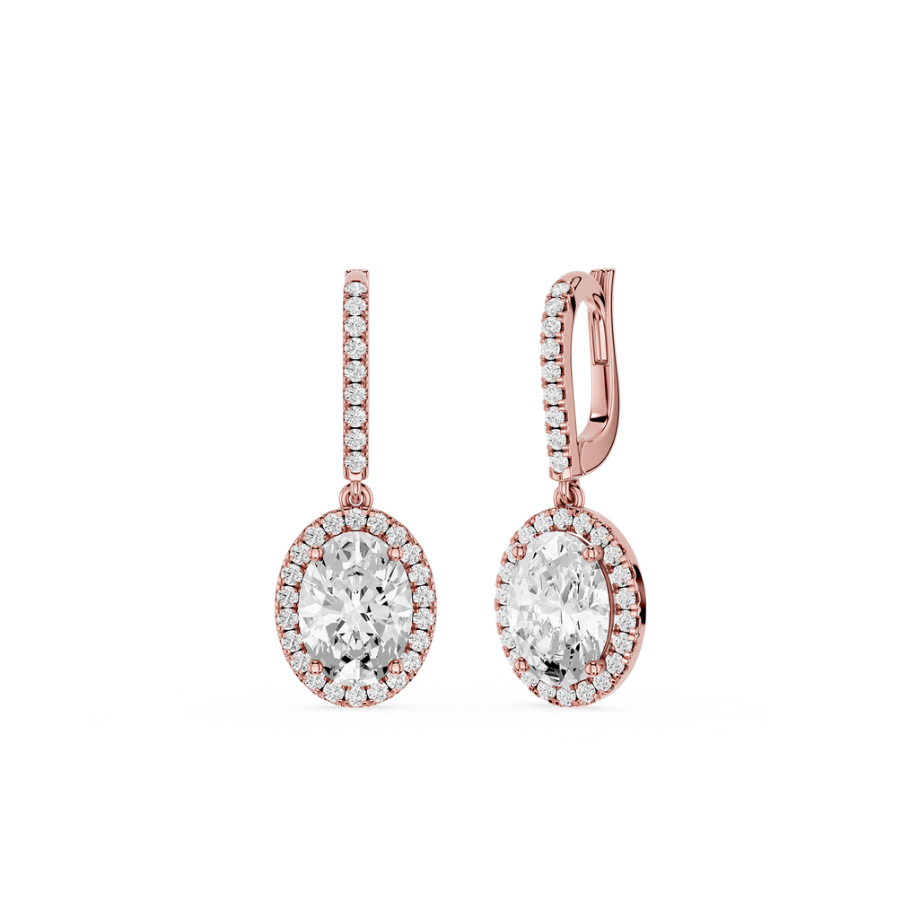 Rose gold earrings with clear gemstones on a white background`