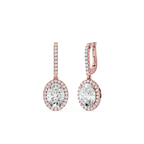 Rose gold earrings with clear gemstones on a white background`