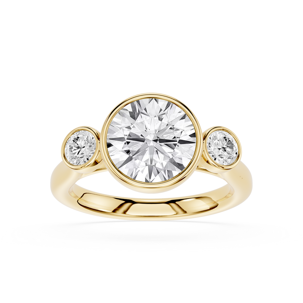 Gold ring with a large central diamond and two smaller diamonds on either side against a white background