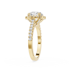 A Yellow gold engagement ring featuring a round-cut diamond center stone in a halo setting, with pave diamonds along the shank, shown on a plain white background.