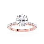 A rose gold engagement ring featuring a round brilliant-cut diamond center stone and a pavé-set diamond band, shown on a clean white background.