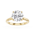 Gold ring with a large diamond on a white background