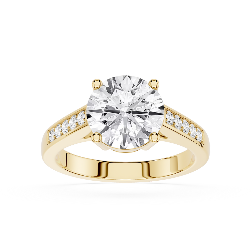 A yellow gold engagement ring featuring a large round-cut diamond center stone and smaller diamonds set along the shoulders, shown on a clean white background.