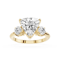 Gold ring with a heart-shaped diamond and two smaller diamonds on a white background