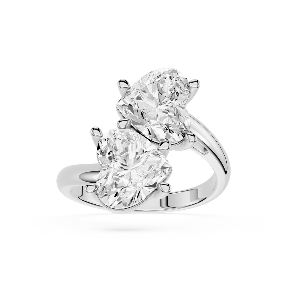 A Silver gold ring featuring two large pear-cut clear gemstones in a split-prong setting, shown on a clean white background.