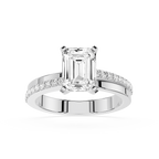Diamond ring with emerald-cut center stone and smaller diamonds on a white background