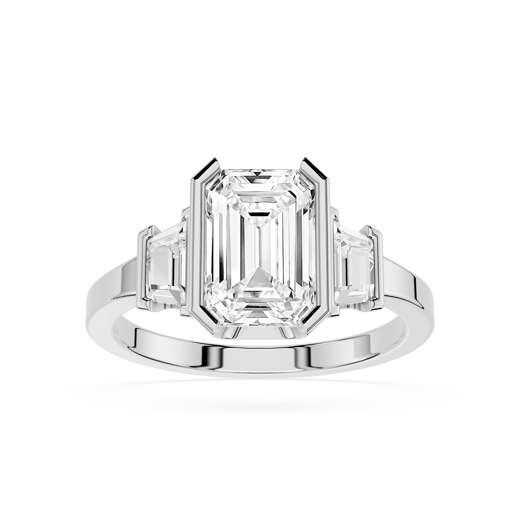 Diamond ring with emerald-cut center stone and baguette side stones on a white background
