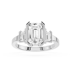 Diamond ring with emerald-cut center stone and baguette side stones on a white background