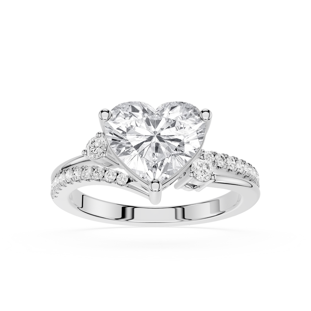 A heart-shaped diamond engagement ring with a brilliant center stone and pavé-set side stones on a polished silver-colored band, shown against a plain white background.