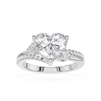A heart-shaped diamond engagement ring with a brilliant center stone and pavé-set side stones on a polished silver-colored band, shown against a plain white background.