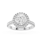 A silver-toned diamond engagement ring with a round-cut center stone, a halo of smaller diamonds, and a shank accented with pave diamonds, shown on a clean white background.