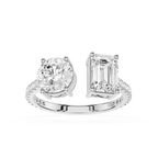 A white gold or platinum split-shank ring featuring a round brilliant-cut diamond on one side and an emerald-cut diamond on the other, set against a plain white background.