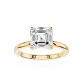 Gold ring with a large diamond on a white background
